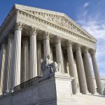 Supreme Court building with statue and columns