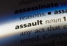 Closeup of the word assault in dictionary