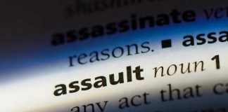 Closeup of the word assault in dictionary