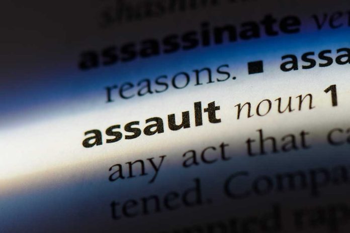 Closeup of the word assault in dictionary