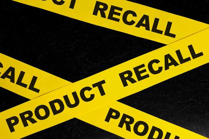 Yellow product recall tape on black background.