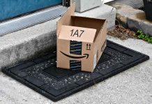 Open Amazon package on doorstep doormat.