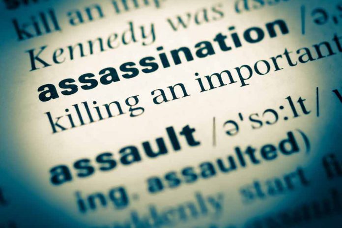 Close-up of dictionary page defining assassination.