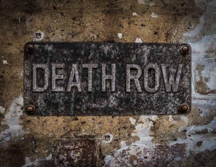 Weathered Death Row sign on aged concrete wall