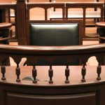 Witness stand in an empty courtroom.