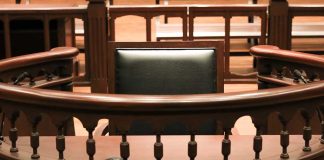 Witness stand in an empty courtroom.