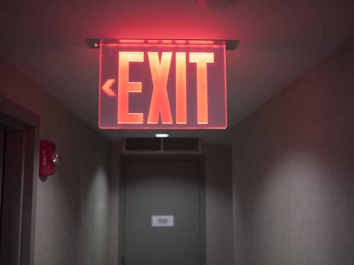 Red illuminated exit sign in a hallway.