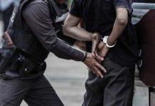 Police officer arresting a person.