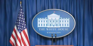 White House podium with American flag and seal.