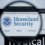 Magnifying glass showing Homeland Security website.