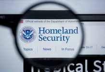 Magnifying glass showing Homeland Security website.