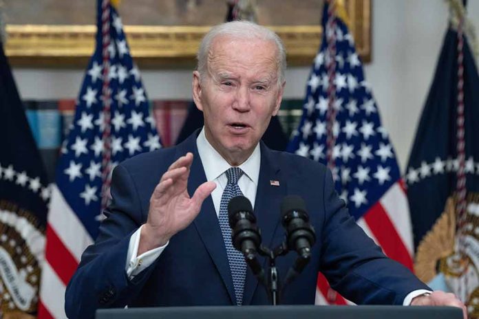 Biden speaking at podium with American flags behind.