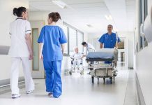 Doctors and nurses in hospital corridor with stretcher