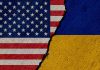 Torn United States and Ukraine flags.