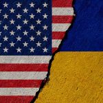 Torn United States and Ukraine flags.