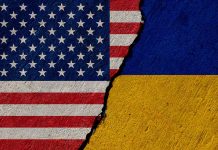 Torn United States and Ukraine flags.