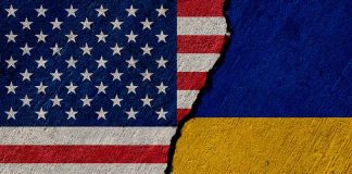 Torn United States and Ukraine flags.