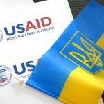 USAID documents with Ukrainian flag on table