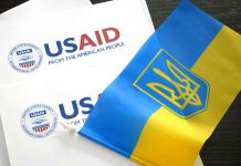 USAID documents with Ukrainian flag on table