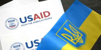 USAID documents with Ukrainian flag on table