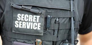 Secret Service vest with various tactical gear attached.