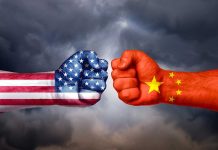 Two fists with American and Chinese flags opposing