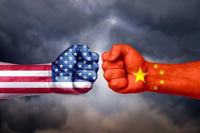 Two fists with American and Chinese flags opposing