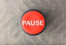 Red button labeled pause on gray background