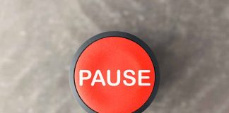 Red button labeled pause on gray background