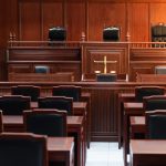Empty courtroom with wooden furniture and chairs