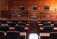 Empty courtroom with wooden furniture and chairs