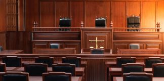 Empty courtroom with wooden furniture and chairs