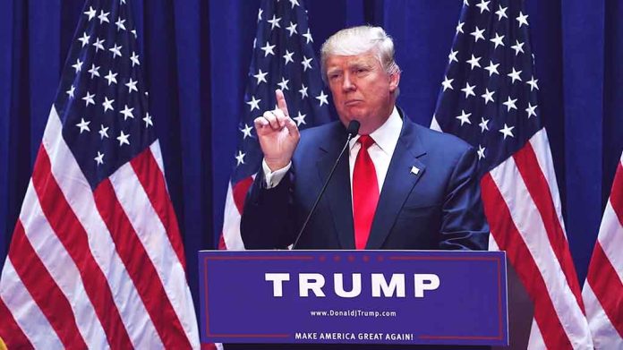 1456399979 featured image Man speaking at podium with American flags behind