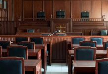 Empty courtroom with wooden furnishings and judge s bench