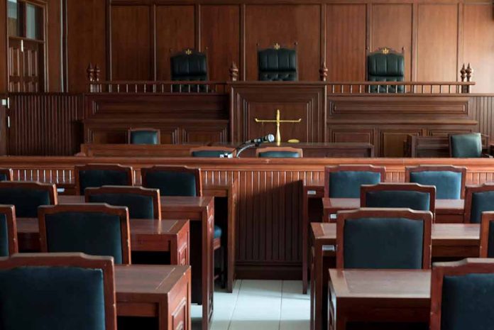 1154521519 featured image Empty courtroom with wooden furnishings and judge s bench