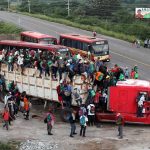 Crowded truck with people on the road