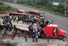 Crowded truck with people on the road