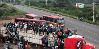 Crowded truck with people on the road