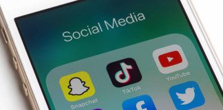 Phone showing social media app icons Snapchat TikTok YouTube