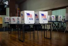 Voting booths with American flag and vote sign