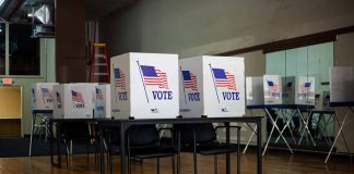 Voting booths with American flag and vote sign