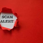 Red paper tear with the words scam alert
