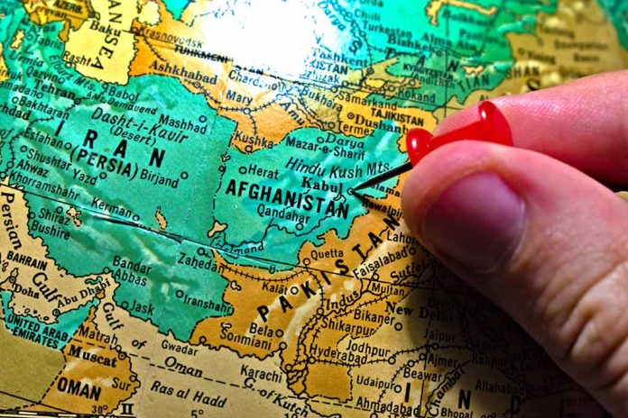 1922414615 featured image Hand placing pin on map of Afghanistan