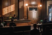 Judge presiding over courtroom with people seated