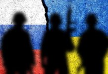 Silhouettes in front of Russian and Ukrainian flags