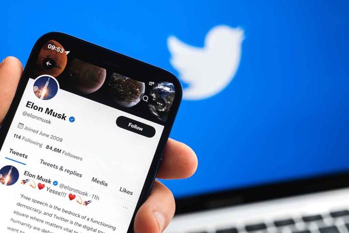 2150043711 featured image Hand holding phone displaying Twitter profile.