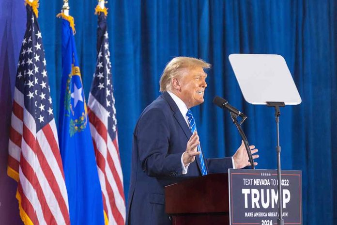 2427935455 featured image Person speaking at podium with flags in background