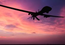 Drone silhouette against vibrant sunset sky