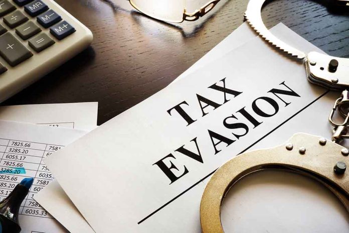 tax evasion document with handcuffs calculator and papers