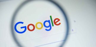 Google logo viewed through a magnifying glass